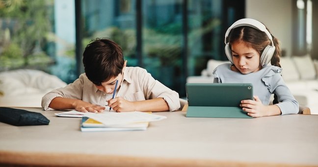 Homework, headphones and children in home with tablet, activity and project or academic app