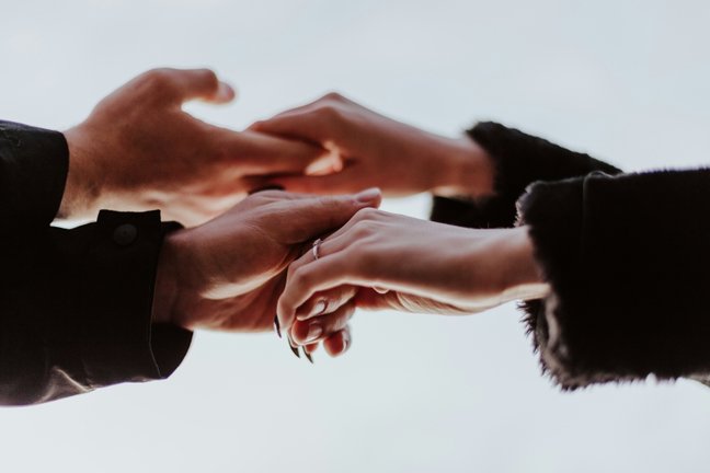 Two people holding hands
